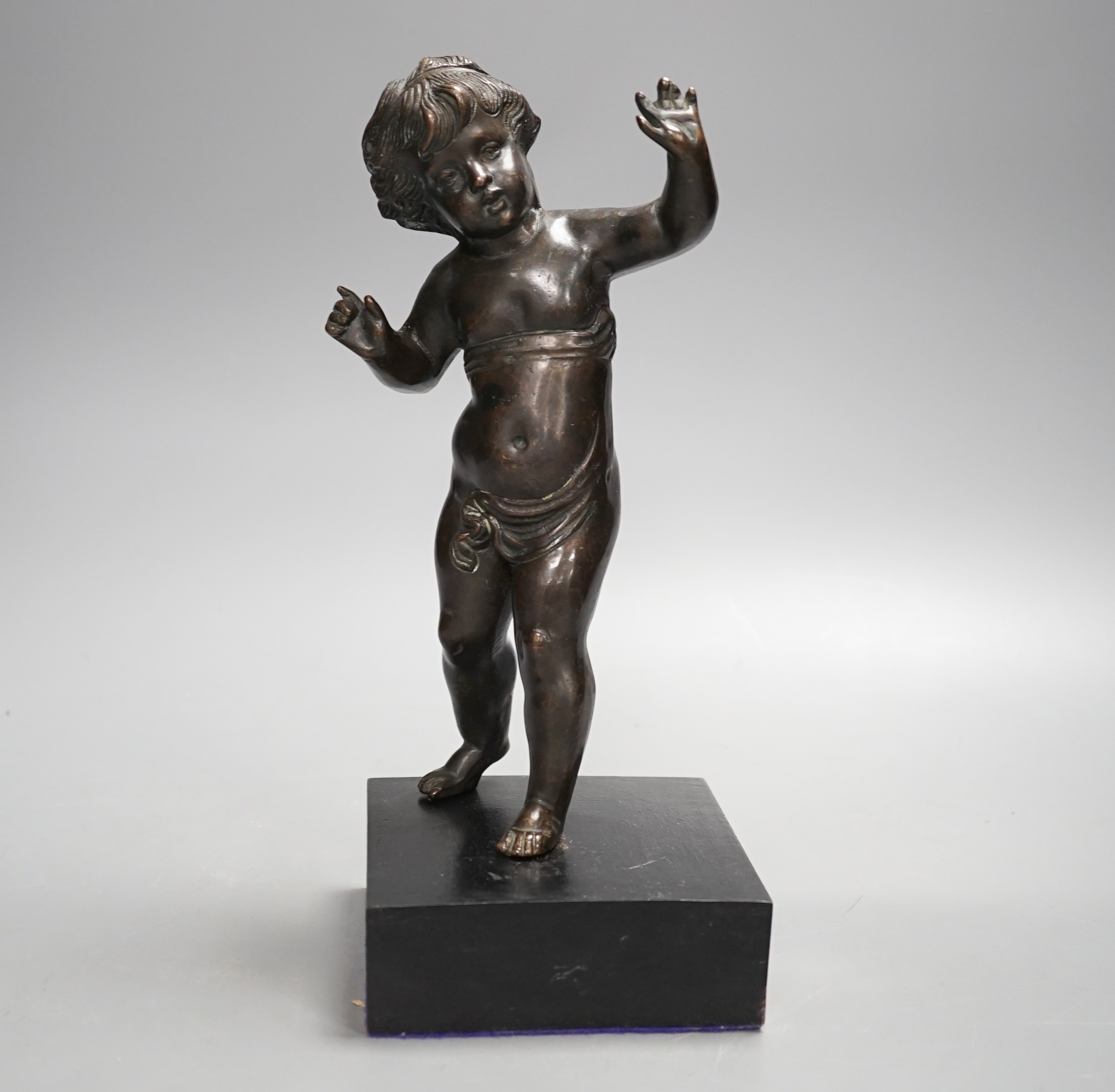 A 20th century bronze putto on wooden stand 29cm including stand